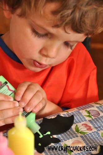 Painting glow in the dark bats is a fun Halloween activity for kids!