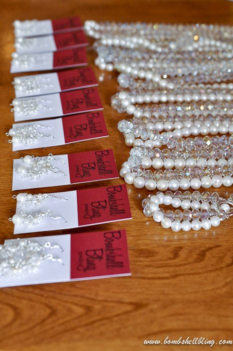 crystal and pearl necklace on table with earrings