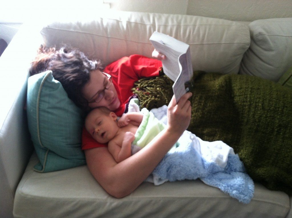 In San Diego snuggling my brand new nephew and reading The Secret Keeper = Heaven.