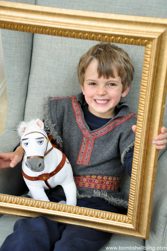 Boy holding gold frame at Bippity Boppity Boutique Party