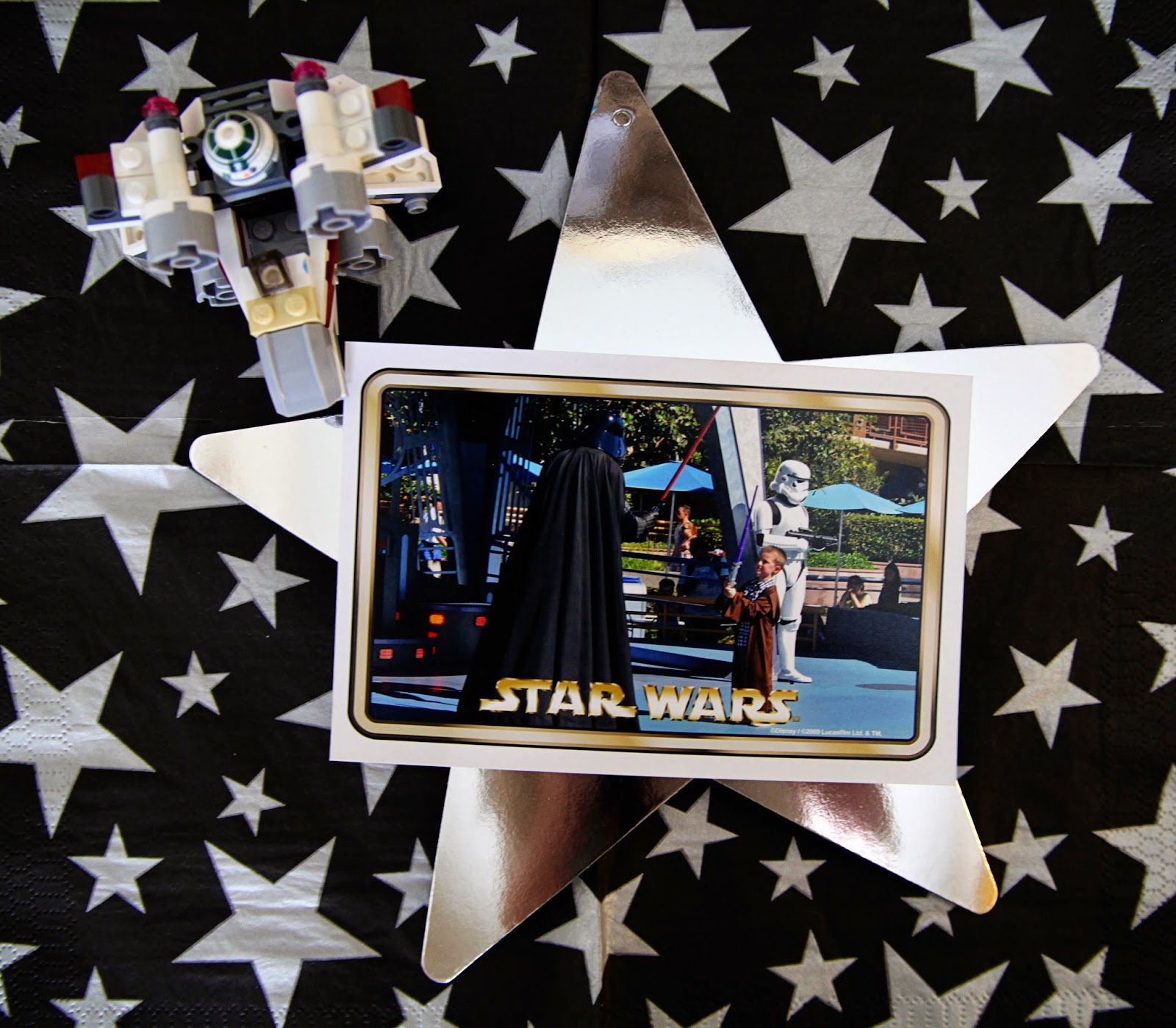 Star Wars Lego table centerpiece photo on silver star next to mini lego figure
