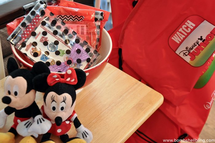 Red party favor bags at disney junior birthday party