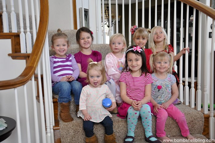 Eight preschoolers sitting on stairs at disney junior birthday party