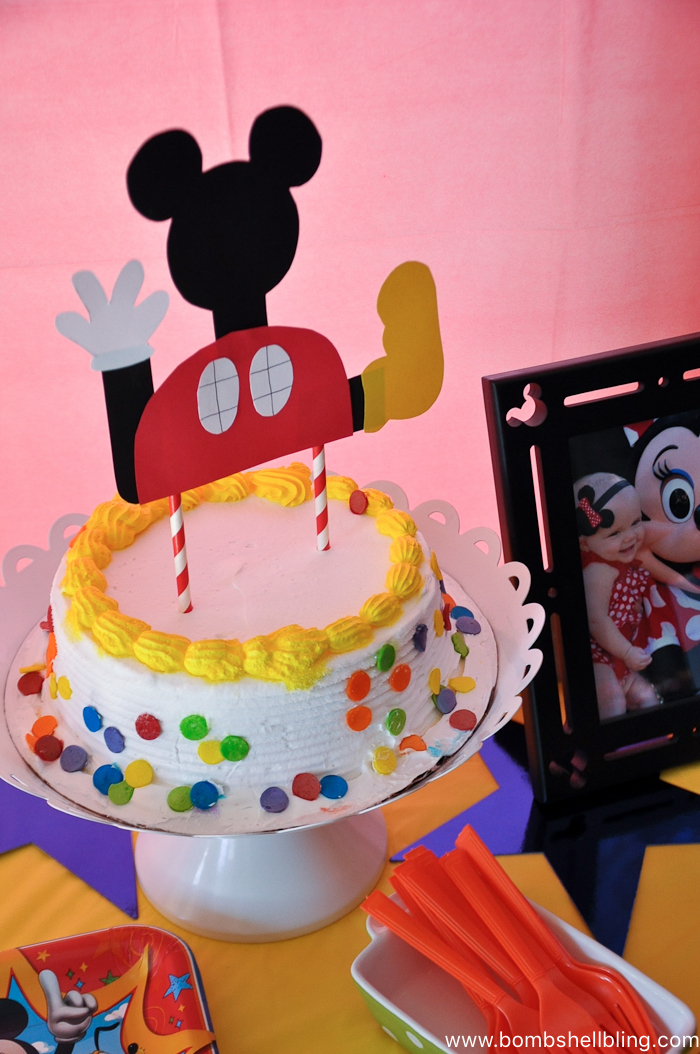 Cake with white frosting and multicolored polka dots for disney junior birthday party