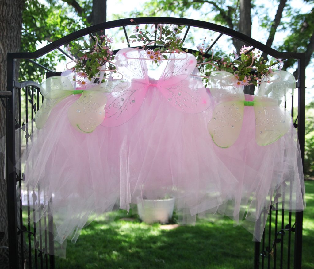 Three pink fairy dresses hanging outside at fairy birthday party