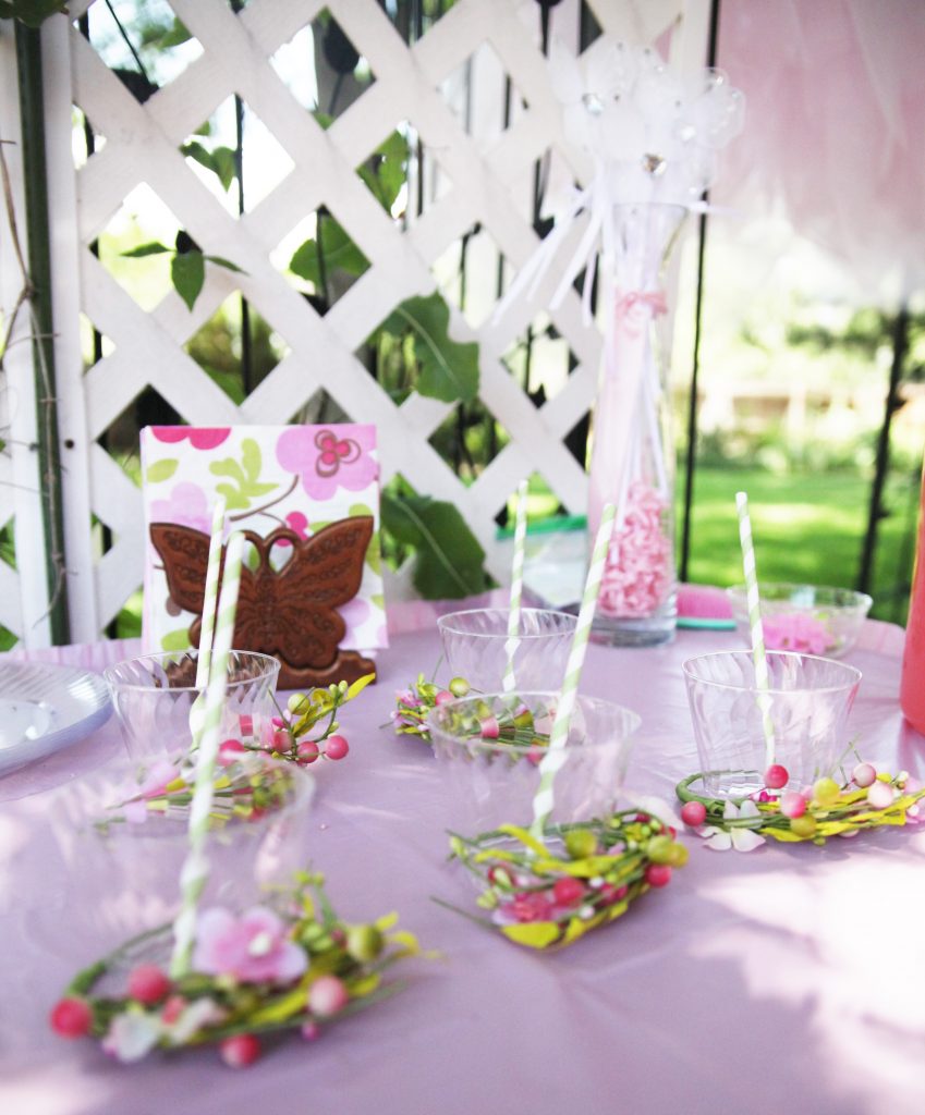 Clear plastic cups with striped straw on table at fairy birthday party