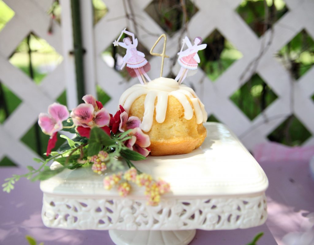 Vanilla cupcake on white cake plate at fairy birthday party