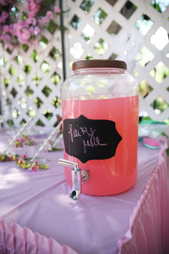 Pink punch in glass jar on table at fairy birthday party